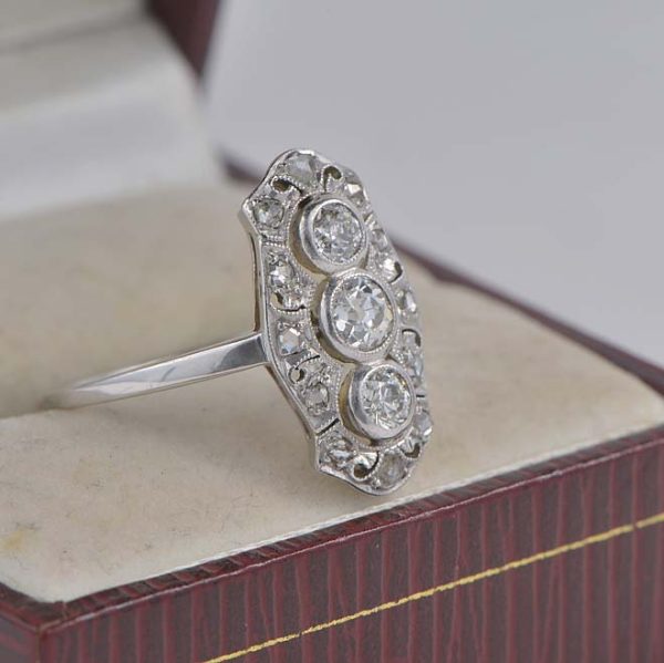 Edwardian Antique 1ct Old Cut Diamond Trilogy Tablet Panel Ring, Three old mine cut diamond set vertically with rose-cut diamond-set decorative pierced border in platinum. Circa 1900