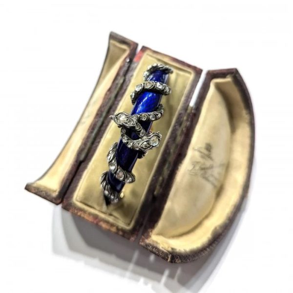 Victorian Antique Blue Enamel and Diamond Set Gold Snake Bangle Bracelet, two entwined diamond set silver snakes on dark blue guilloché enamel tapering hinged gold bangle. Mid 19th century Circa 1850. Presented in antique double door case