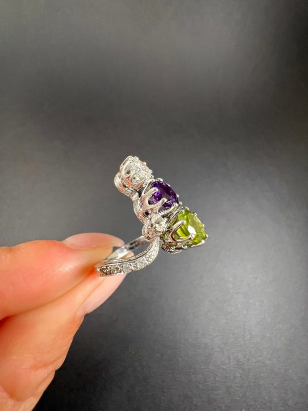Edwardian Antique French Suffragette Amethyst Peridot Diamond Three Stone Ring, graduating trilogy of peridot amethyst and diamond arranged vertically up the finger when worn in 18ct white gold on diamond-set band with French eagles head stamp