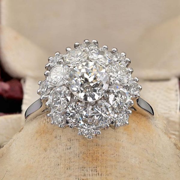 Vintage 2.95ct Diamond Cluster Engagement Ring, 0.95ct old European-cut diamond surrounded by 2cts round brilliant-cut diamonds in floral and petal design in 18ct white gold. Circa 1950s