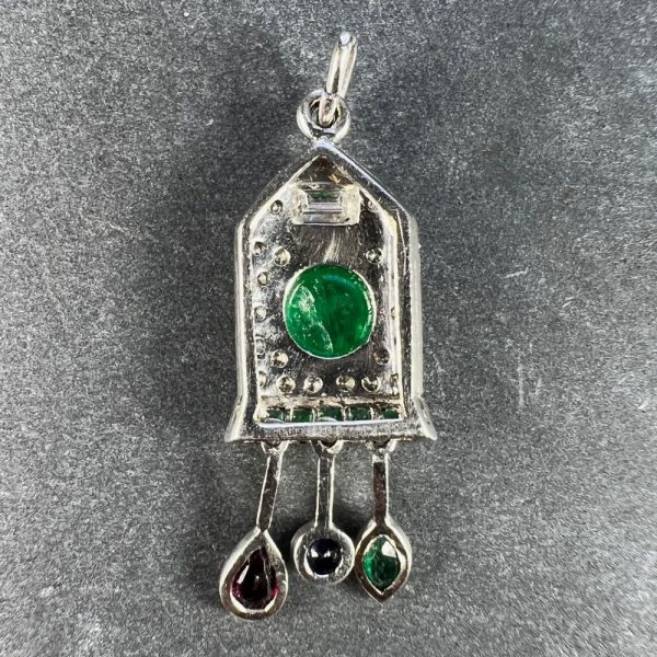 Art Deco Emerald and Diamond Pendant with Ruby Sapphire, platinum charm pendant designed as a diamond and emerald cuckoo clock with sapphire, ruby and emerald weights and pendulum