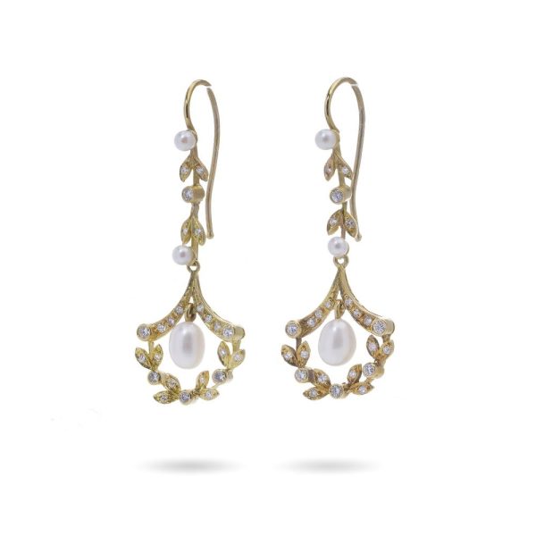 Diamond and pearl drop earrings in gold.