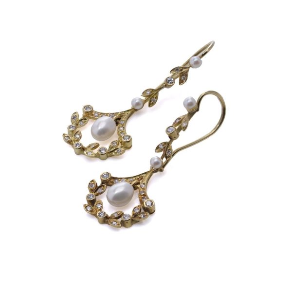 Diamond and pearl drop earrings in gold.
