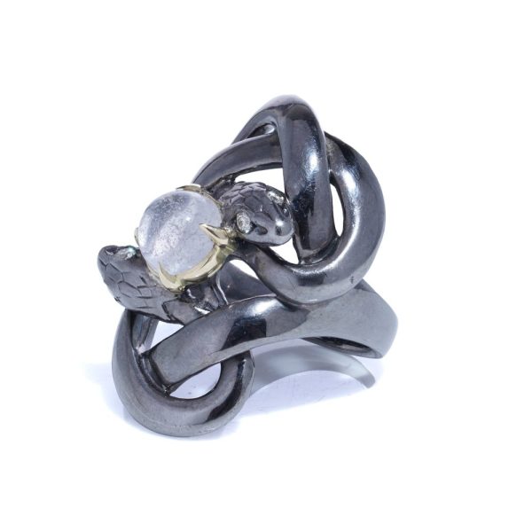 Silver and gold double snake ring with moonstone and diamonds.