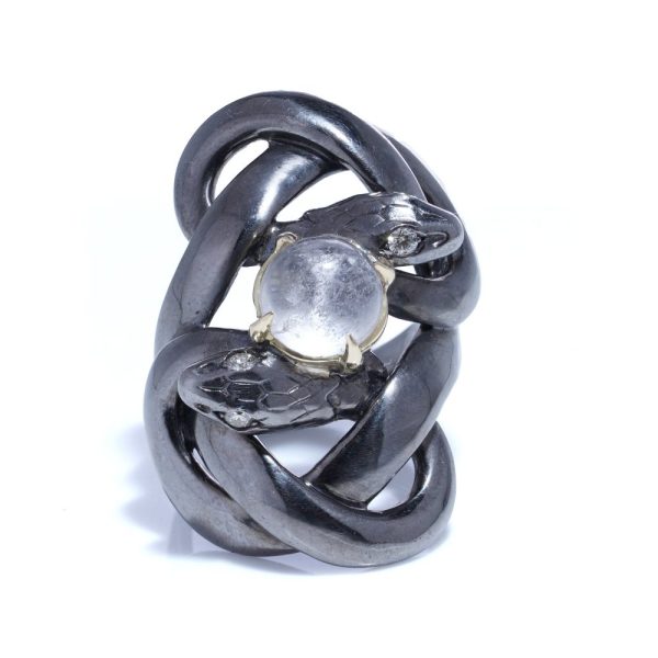Silver and gold double snake ring with moonstone and diamonds.