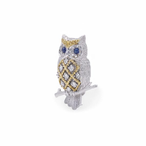 Diamond owl brooch with sapphire eyes in white and yellow gold.