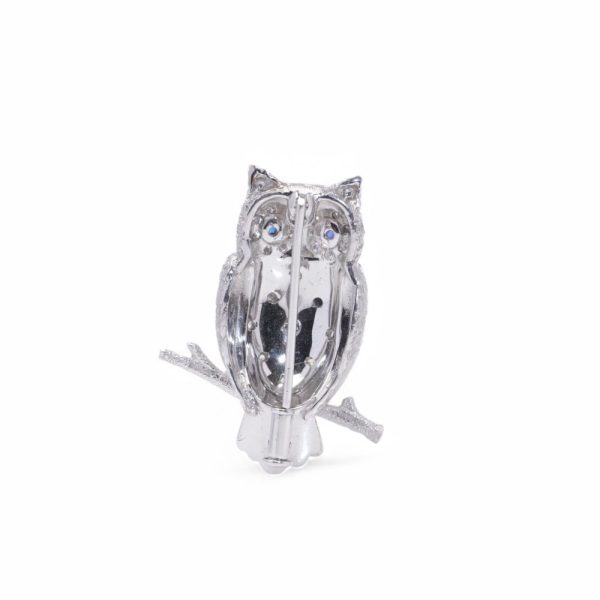 Diamond owl brooch with sapphire eyes in white and yellow gold.