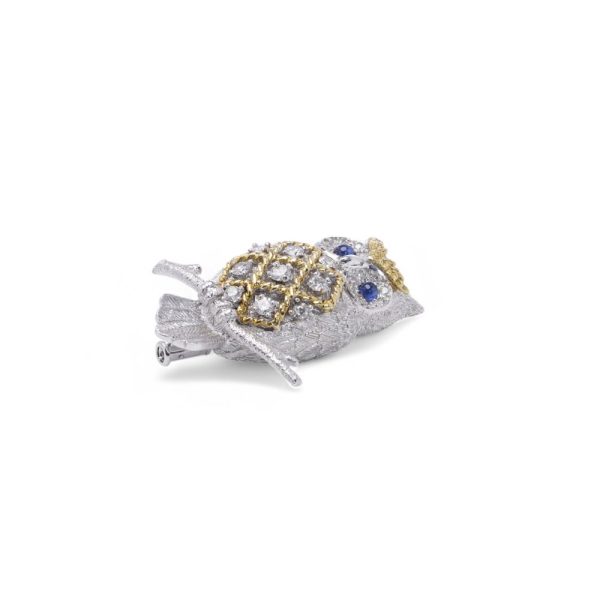 Diamond owl brooch with sapphire eyes in white and yellow gold.