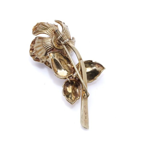 Gold flower brooch with sapphires and rubies.