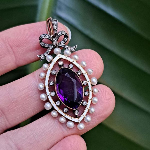 Edwardian Antique Marquise Amethyst Pearl and Diamond Pendant, marquise-cut amethyst surrounded by rose-cut diamonds within white enamel border with gold detailing and natural pearls to outer edge with diamond-set bow bail