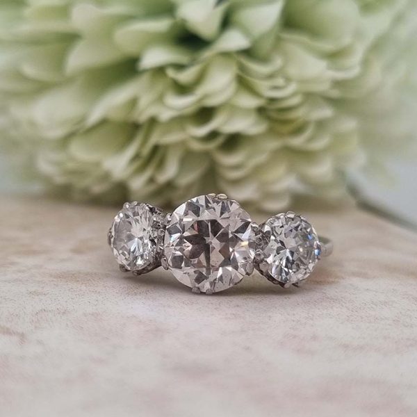 Antique Diamond Three Stone Trilogy Engagement Ring in Platinum, 3.21 carats, 2.01ct old European cut diamond flanked by 1.20cts diamonds with certificate