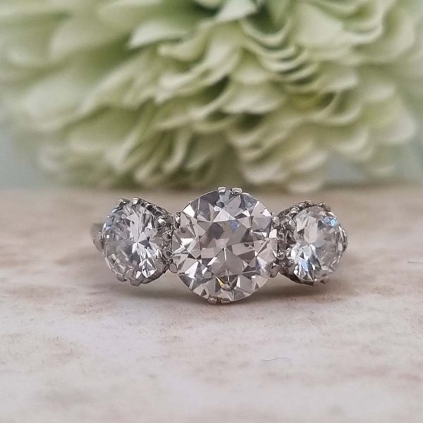 Antique Diamond Three Stone Trilogy Engagement Ring in Platinum, 3.21 carats, 2.01ct old European cut diamond flanked by 1.20cts diamonds with certificate