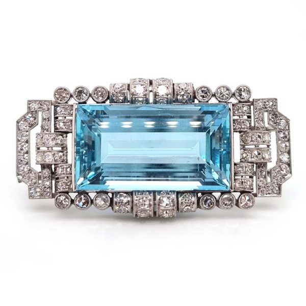 Art Deco 30ct Aquamarine and Diamond Cluster Brooch in Platinum, 30ct rectangular step-cut aquamarine set within geometric scrolled surround studded with sparkling diamonds
