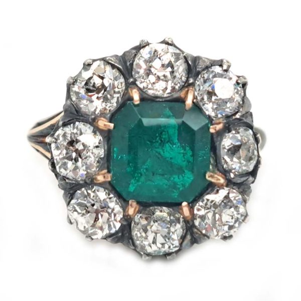 Georgian Regency Antique 2.85ct Colombian Emerald and 4.80ct Old Mine Cut Diamond Cluster Ring in silver upon gold with decorative carved split shank. Circa 1830
