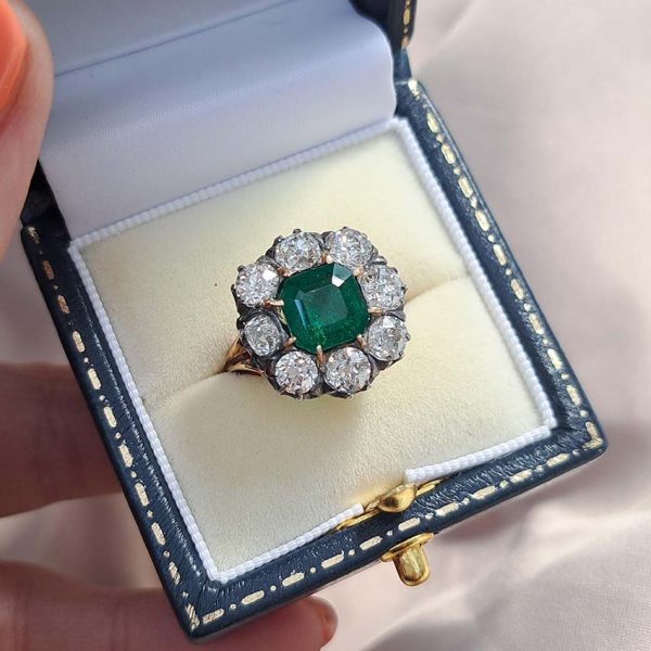 Georgian Regency Antique 2.85ct Colombian Emerald and 4.80ct Old Mine Cut Diamond Cluster Ring in silver upon gold with decorative carved split shank. Circa 1830