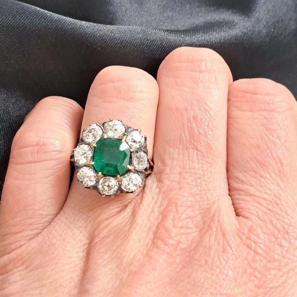 Georgian Regency Antique 2.85ct Colombian Emerald and 4.80ct Old Mine Cut Diamond Cluster Ring in silver upon gold with decorative carved split shank. Circa 1830