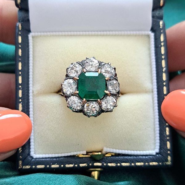 Georgian Regency Antique 2.85ct Colombian Emerald and 4.80ct Old Mine Cut Diamond Cluster Ring in silver upon gold with decorative carved split shank. Circa 1830