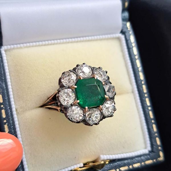 Georgian Regency Antique 2.85ct Colombian Emerald and 4.80ct Old Mine Cut Diamond Cluster Ring in silver upon gold with decorative carved split shank. Circa 1830