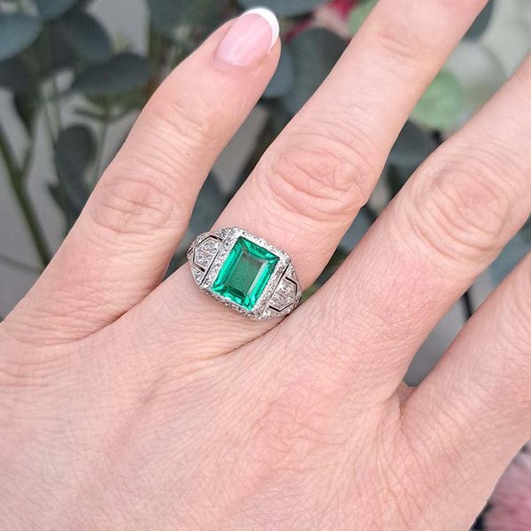 Belle Epoque Edwardian Antique 2.10ct Emerald and Diamond Cluster Ring in Platinum, 2.10ct rectangular step-cut vivid green emerald in diamond mount with openwork design to shoulders and scrolling gallery with engraved shank. Circa 1900