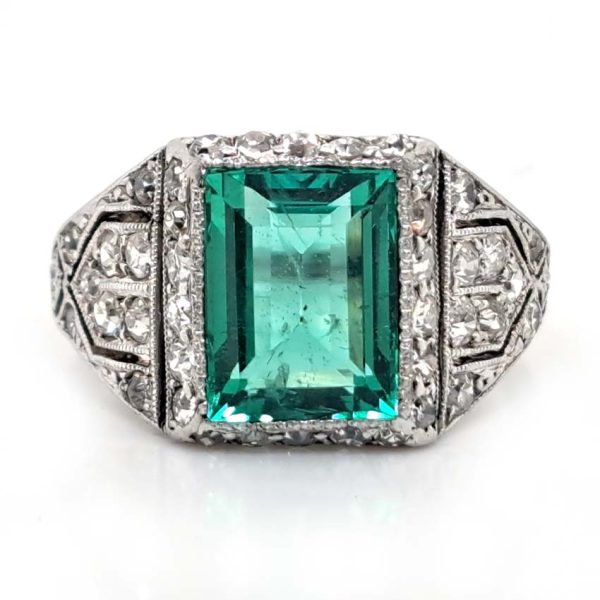 Belle Epoque Edwardian Antique 2.10ct Emerald and Diamond Cluster Ring in Platinum, 2.10ct rectangular step-cut vivid green emerald in diamond mount with openwork design to shoulders and scrolling gallery with engraved shank. Circa 1900