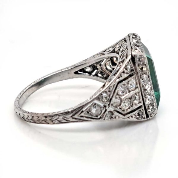 Belle Epoque Edwardian Antique 2.10ct Emerald and Diamond Cluster Ring in Platinum, 2.10ct rectangular step-cut vivid green emerald in diamond mount with openwork design to shoulders and scrolled gallery with engraved shank. Circa 1900