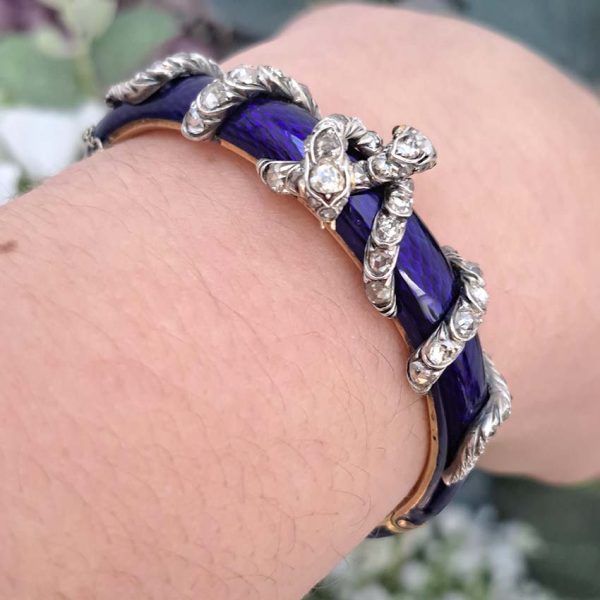 Victorian Antique Blue Enamel and Diamond Set Gold Snake Bangle Bracelet, two entwined diamond set silver snakes on dark blue guilloché enamel tapering hinged gold bangle. Mid 19th century Circa 1850. Presented in antique double door case
