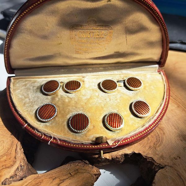 Cartier Art Deco Enamel and Gold Cufflinks Dress Set, circular pair of cufflinks and four buttons with red guilloche enamel and gold stripes and white dot enamel borders. In original Cartier red morocco case, Circa 1930