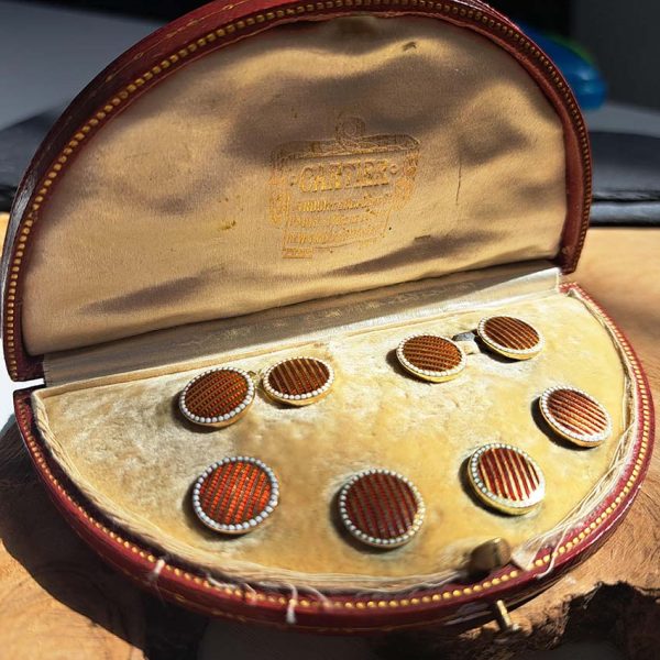 Cartier Art Deco Enamel and Gold Cufflinks Dress Set, circular pair of cufflinks and four buttons with red guilloche enamel and gold stripes and white dot enamel borders. In original Cartier red morocco case, Circa 1930