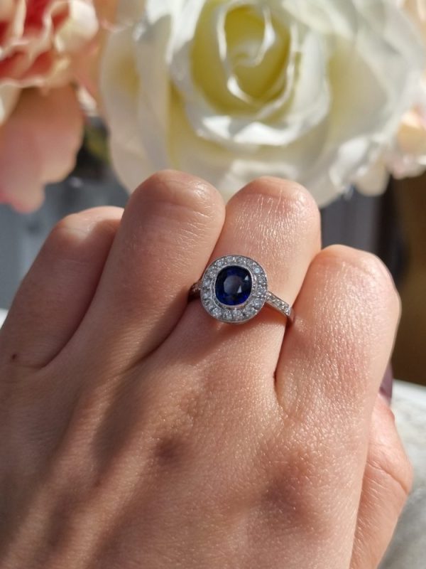 cushion cut sapphire and diamond cluster ring set in 18ct white gold