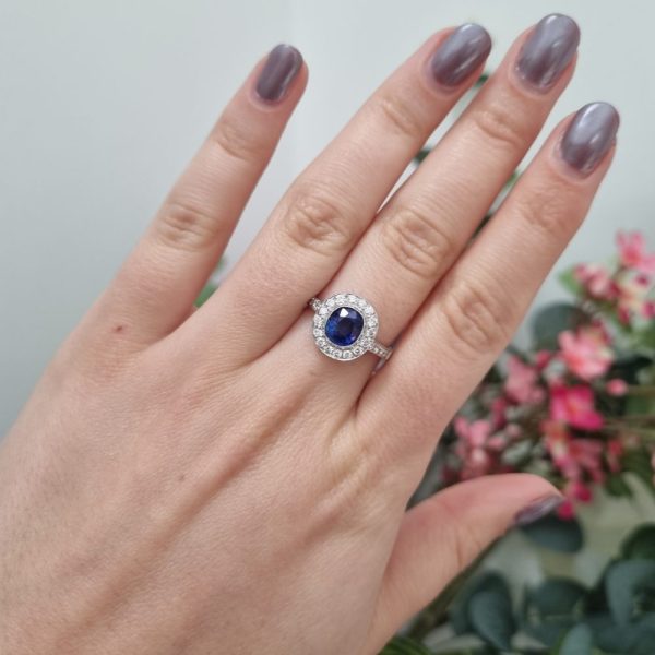 cushion cut sapphire and diamond cluster ring set in 18ct white gold