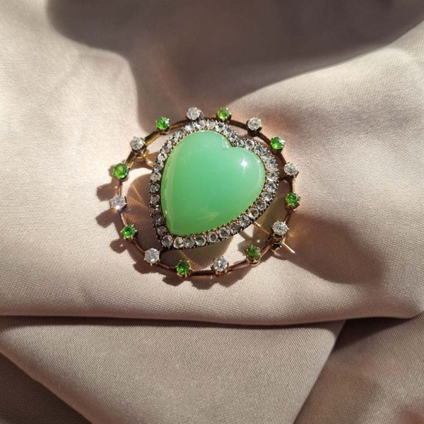 Antique Chalcedony Heart Brooch with Demantoid Garnet and Diamond, heart shaped cabochon chalcedony surrounded by fixed halo of alternating diamonds and demantoid garnets in 15ct yellow gold