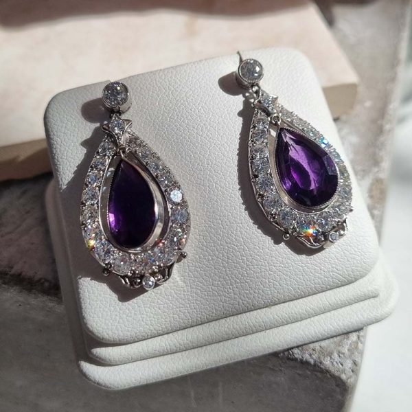 Antique 6.40ct Pear Cut Amethyst and 2ct Diamond Cluster Drop Earrings, pear-shaped amethysts suspended within fixed single-cut and old-cut diamond surrounds to old European-cut diamond solitaire tops in platinum