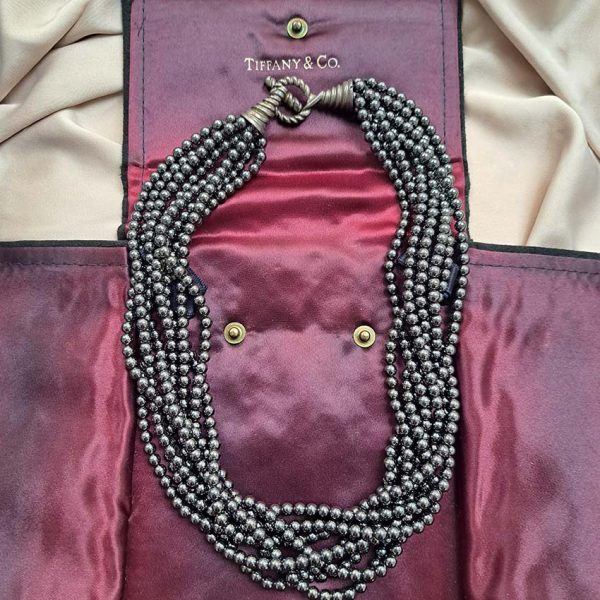 Pre Owned Tiffany and Co Hematite Bead Necklace, eight strands of rich hematite beads leading to a twisted silver hoop and T-bar clasp in Tiffany & Co pouch