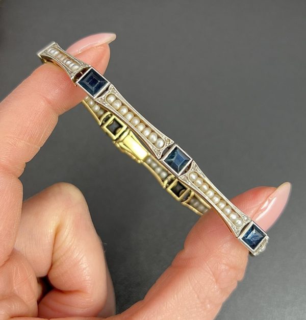 Edwardian Antique Sapphire and Seed Pearl Link Bracelet, long rectangular links with delicate row of natural seed pearls interspersed with square-cut sapphires in platinum and 18ct yellow gold.. Circa 1910