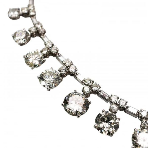 Vintage French Diamond Riviere Necklace in Platinum, 37.84 carats, graduating brilliant diamond drops on articulating chain of alternating pairs of round brilliant-cut diamonds, with baguette-cut diamonds. Circa 1950s