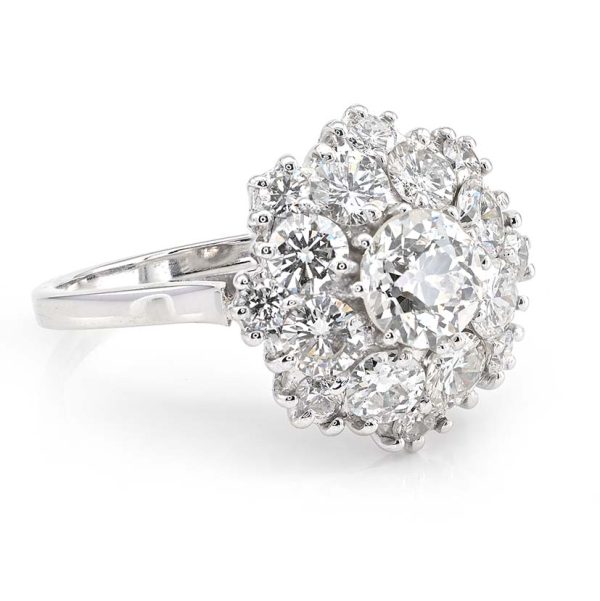 Vintage 2.95ct Diamond Cluster Engagement Ring, 0.95ct old European-cut diamond surrounded by 2cts round brilliant-cut diamonds in floral and petal design in 18ct white gold. Circa 1950s