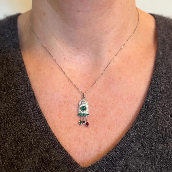 Art Deco Emerald and Diamond Pendant with Ruby Sapphire, platinum charm pendant designed as a diamond and emerald cuckoo clock with sapphire, ruby and emerald weights and pendulum