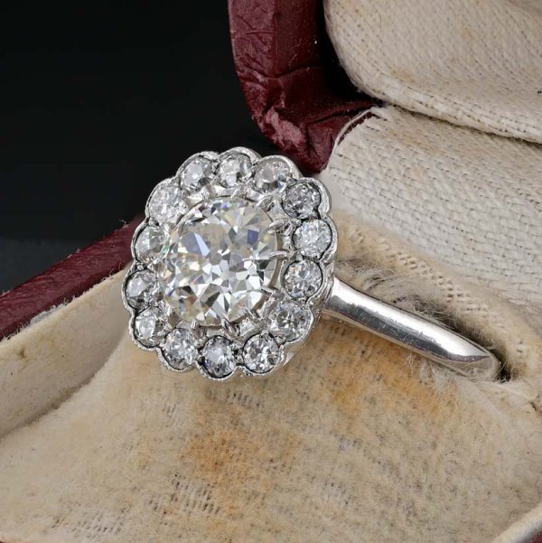 Late Art Deco Diamond Cluster Engagement Ring, 1.60 carats, 1.15ct old European cut diamond within 0.45ct sparkling diamond surround in platinum. Circa 1935