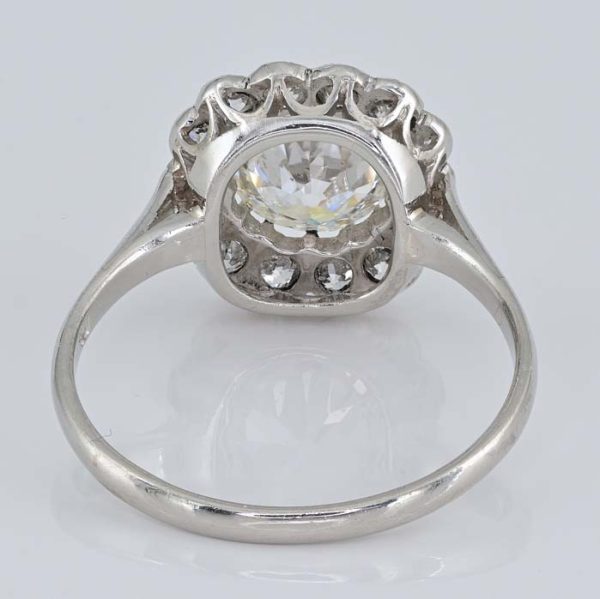 Late Art Deco Diamond Cluster Engagement Ring, 1.60 carats, 1.15ct old European cut diamond within 0.45ct sparkling diamond surround in platinum. Circa 1935