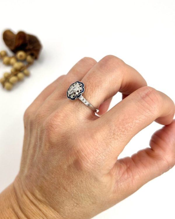 Art Deco Inspired Marquise Diamond and Sapphire Cluster Dress Ring in Platinum, marquise-cut diamond within diamond set intricate open-work design surround and outer border of calibre sapphires. Circa 2000