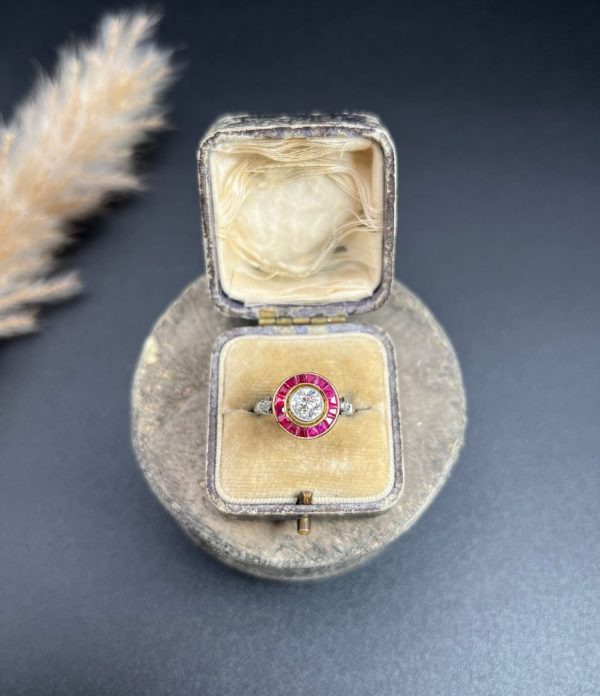 Vintage Antique Art Deco Diamond and Ruby Halo Target Cluster Engagement Ring, 0.65ct diamond framed by border of calibre red rubies in platinum and 18ct yellow gold. Circa 1920s