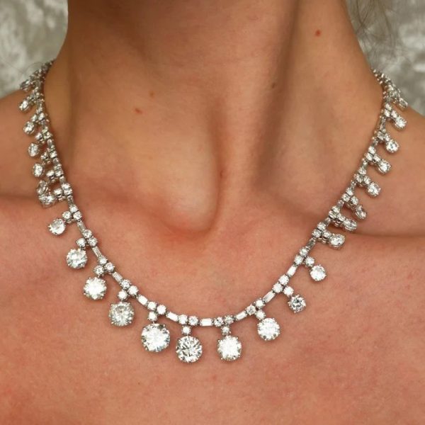 Vintage French Diamond Riviere Necklace in Platinum, 37.84 carats, graduating brilliant diamond drops on articulating chain of alternating pairs of round brilliant-cut diamonds, with baguette-cut diamonds. Circa 1950s