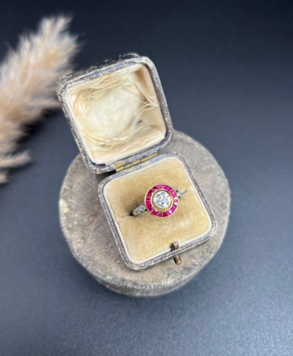 Vintage Antique Art Deco Diamond and Ruby Halo Target Cluster Engagement Ring, 0.65ct diamond framed by border of calibre red rubies in platinum and 18ct yellow gold. Circa 1920s