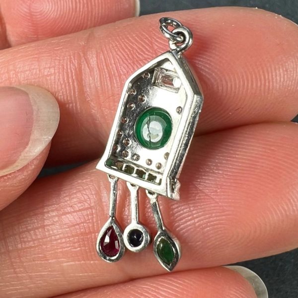 Art Deco Emerald and Diamond Pendant with Ruby Sapphire, platinum charm pendant designed as a diamond and emerald cuckoo clock with sapphire, ruby and emerald weights and pendulum