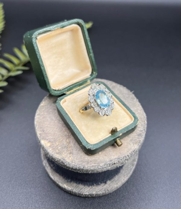 Vintage 2ct Aquamarine and Diamond Cluster Engagement Ring, oval aquamarine surrounded by 2cts sparkling diamonds set in white gold to 18ct yellow gold band with elegant pinched shoulders. Circa 1960s