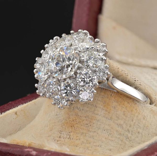 Vintage 2.95ct Diamond Cluster Engagement Ring, 0.95ct old European-cut diamond surrounded by 2cts round brilliant-cut diamonds in floral and petal design in 18ct white gold. Circa 1950s