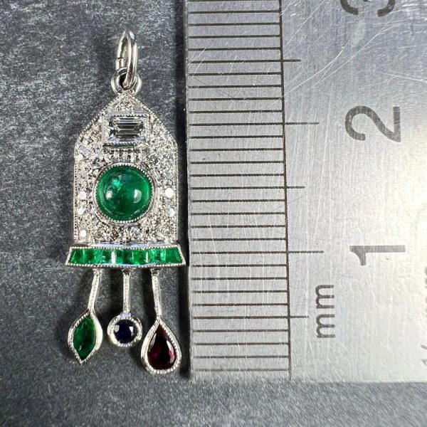 Art Deco Emerald and Diamond Pendant with Ruby Sapphire, platinum charm pendant designed as a diamond and emerald cuckoo clock with sapphire, ruby and emerald weights and pendulum