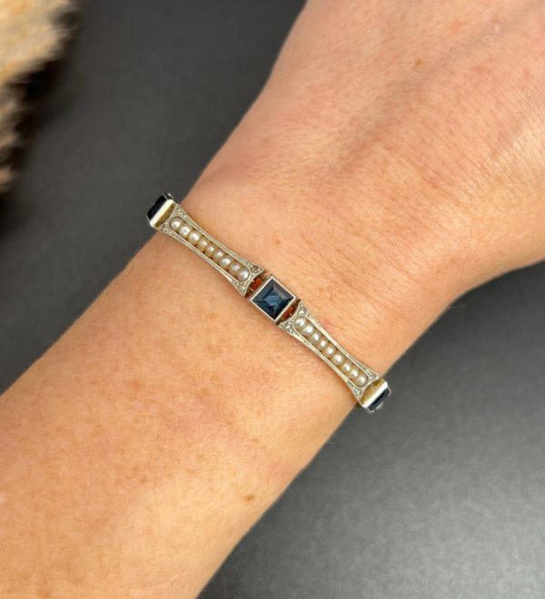 Edwardian Antique Sapphire and Seed Pearl Link Bracelet, long rectangular links with delicate row of natural seed pearls interspersed with square-cut sapphires in platinum and 18ct yellow gold.. Circa 1910