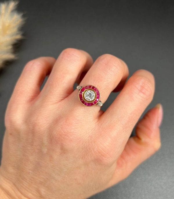 Vintage Antique Art Deco Diamond and Ruby Halo Target Cluster Engagement Ring, 0.65ct diamond framed by border of calibre red rubies in platinum and 18ct yellow gold. Circa 1920s