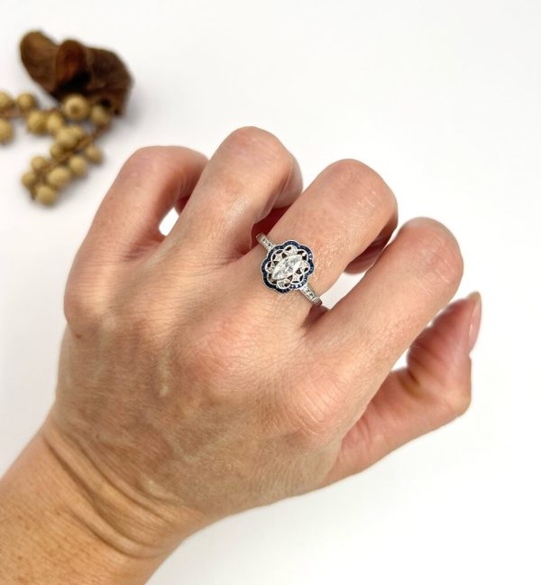Art Deco Inspired Marquise Diamond and Sapphire Cluster Dress Ring in Platinum, marquise-cut diamond within diamond set intricate open-work design surround and outer border of calibre sapphires. Circa 2000